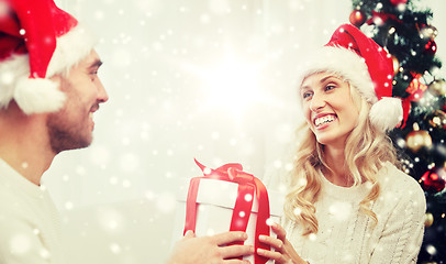 Image showing happy couple at home with christmas gift box