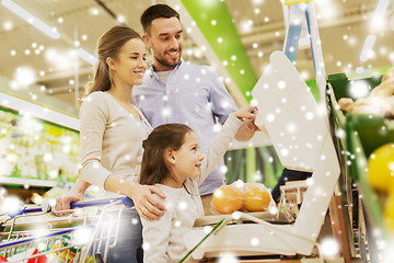 Image showing family weighing oranges on scale at grocery store