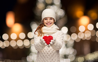 Image showing happy girl in winter clothes with red heart