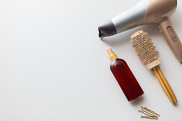 Image showing hairdryer, brush, hot styling hair spray and pins