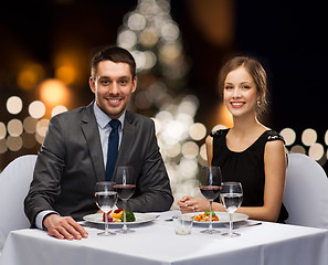 Image showing couple at served restaurant table at christmas