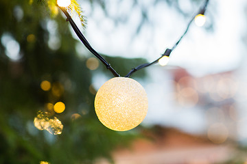 Image showing close up of fir with christmas tree toys outdoors