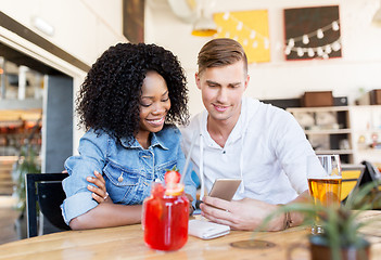 Image showing happy man and woman with smartphone at bar