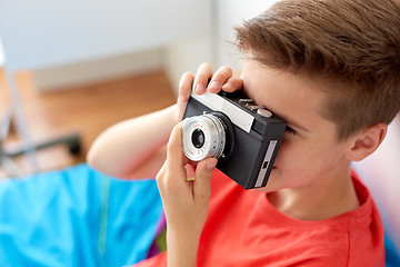 Image showing close up of boy photographing by film camera