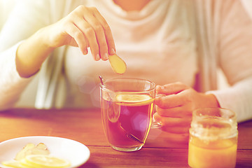 Image showing close up of ill woman drinking tea with ginger