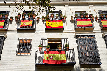 Image showing The national flag of Spain hang on the balcony in a street