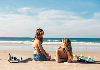 Image showing Two surfer girls at the beach