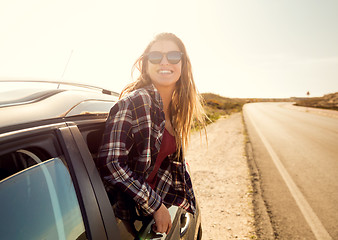 Image showing happy girl looking out the car window