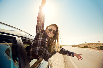 Image showing happy girl looking out the car window