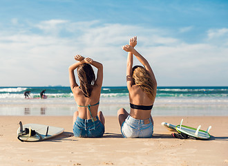 Image showing Two surfer girls at the beach