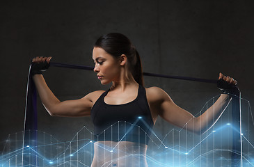 Image showing woman with expander exercising in gym