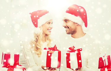 Image showing happy couple at home exchanging christmas gifts