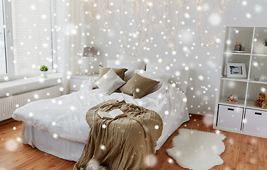 Image showing bedroom with bed and christmas garland at home