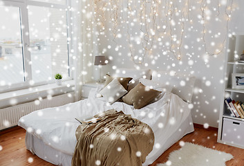 Image showing bedroom with bed and christmas garland at home