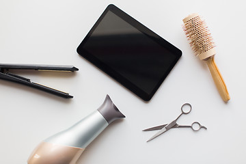 Image showing tablet pc, scissors, hairdryer, hot iron and brush