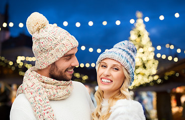 Image showing happy couple over christmas tree lights