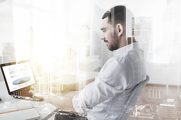 Image showing businessman with charts on laptop screen at office