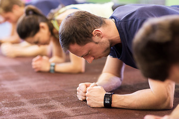 Image showing man with heart-rate tracker exercising in gym