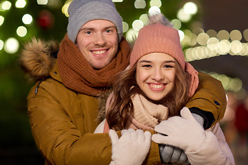 Image showing happy couple hugging at christmas tree