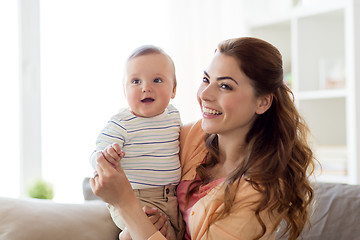 Image showing happy young mother with little baby at home