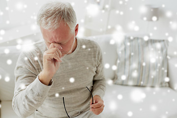 Image showing senior man suffering from headache at home