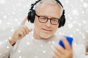 Image showing happy senior man with smartphone and headphones