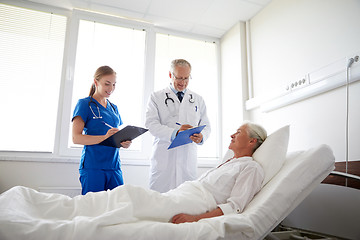 Image showing doctor and nurse visiting senior woman at hospital