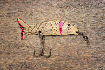 Image showing Retro rusty lure on the wooden background