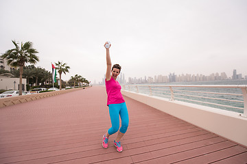 Image showing young woman celebrating a successful training run