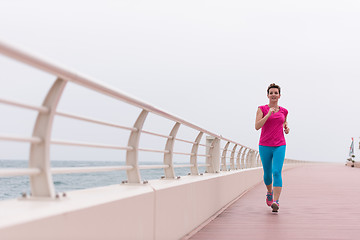 Image showing woman busy running on the promenade