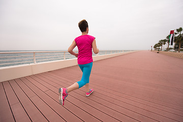 Image showing woman busy running on the promenade