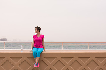 Image showing young woman sitting after a successful training run