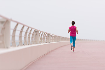 Image showing woman busy running on the promenade