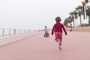 Image showing mother and cute little girl on the promenade by the sea