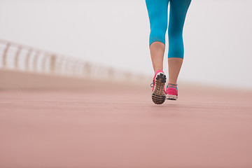 Image showing woman busy running on the promenade