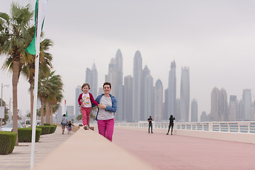 Image showing mother and cute little girl on the promenade