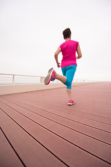 Image showing woman busy running on the promenade