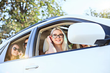 Image showing The young women in the car smiling