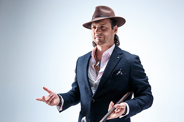 Image showing Young man portrait with hat on gray studio background.