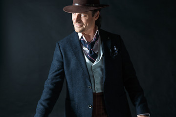 Image showing Young man portrait with hat on gray studio background.