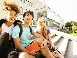 Image showing cute group of teenages at the building of university with books huggings, back to school