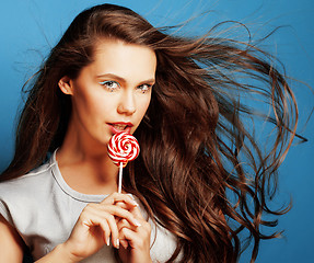 Image showing young pretty adorable woman with candy close up like doll