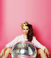Image showing young cute disco girl on pink background with disco ball and cro