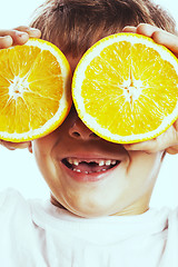 Image showing little cute boy with orange fruit double isolated on white smili