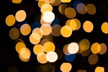 Image showing blurred golden lights over dark background