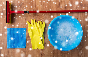 Image showing squeegee with window cleaning stuff on wood