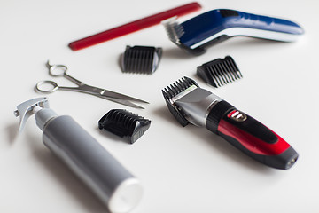 Image showing styling hair sprays, clippers, comb and scissors