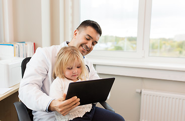 Image showing doctor and little girl with tablet pc at clinic