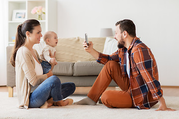 Image showing happy family with baby photographing at home