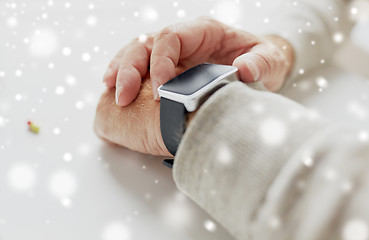 Image showing close up of old man hand with pill and smart watch